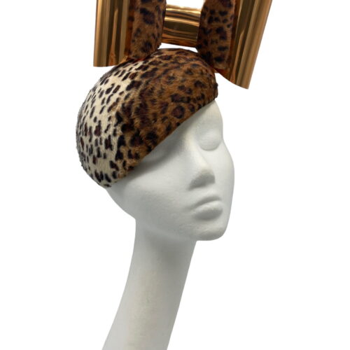 Leopard print teardrop headpiece with a beautiful bow to the top with a shiny gold front to the bow.